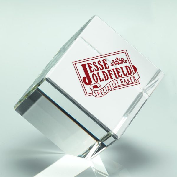 Image showing glass cube paperweight with coloured in red engraving