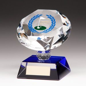 Image showing nearest the pin blue glass diamond against cream background